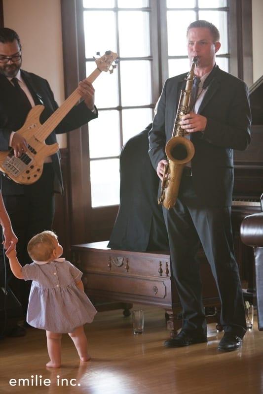 saxophone player with baby watching