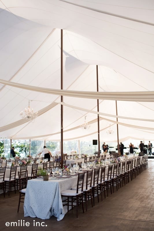white tent with long table fo chairs for guests