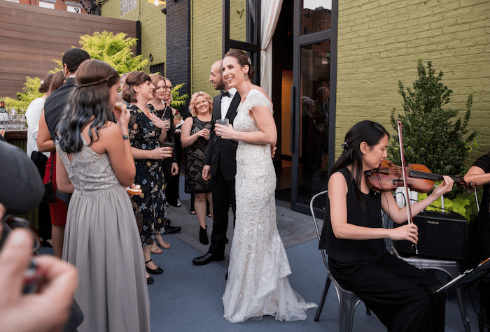 bride talking to guests wedding reception string quartet